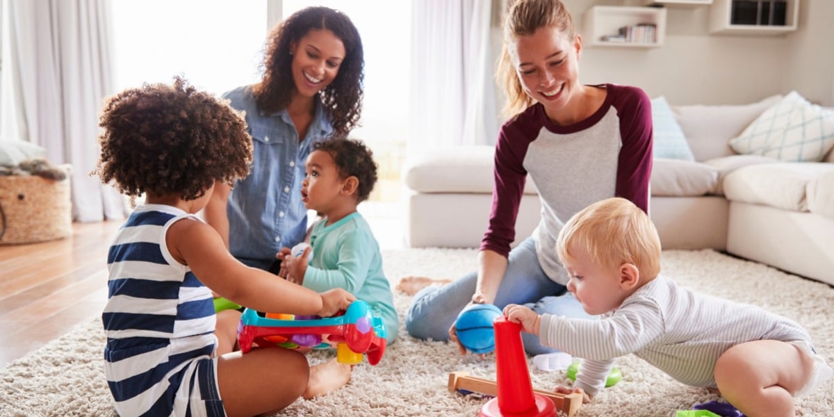 https://6691866.fs1.hubspotusercontent-na1.net/hubfs/6691866/Archive/Archived%20Folder/Parents%20supporting%20each%20other%20and%20playing%20with%20their%20toddlers%20in%20the%20sitting%20room.jpeg